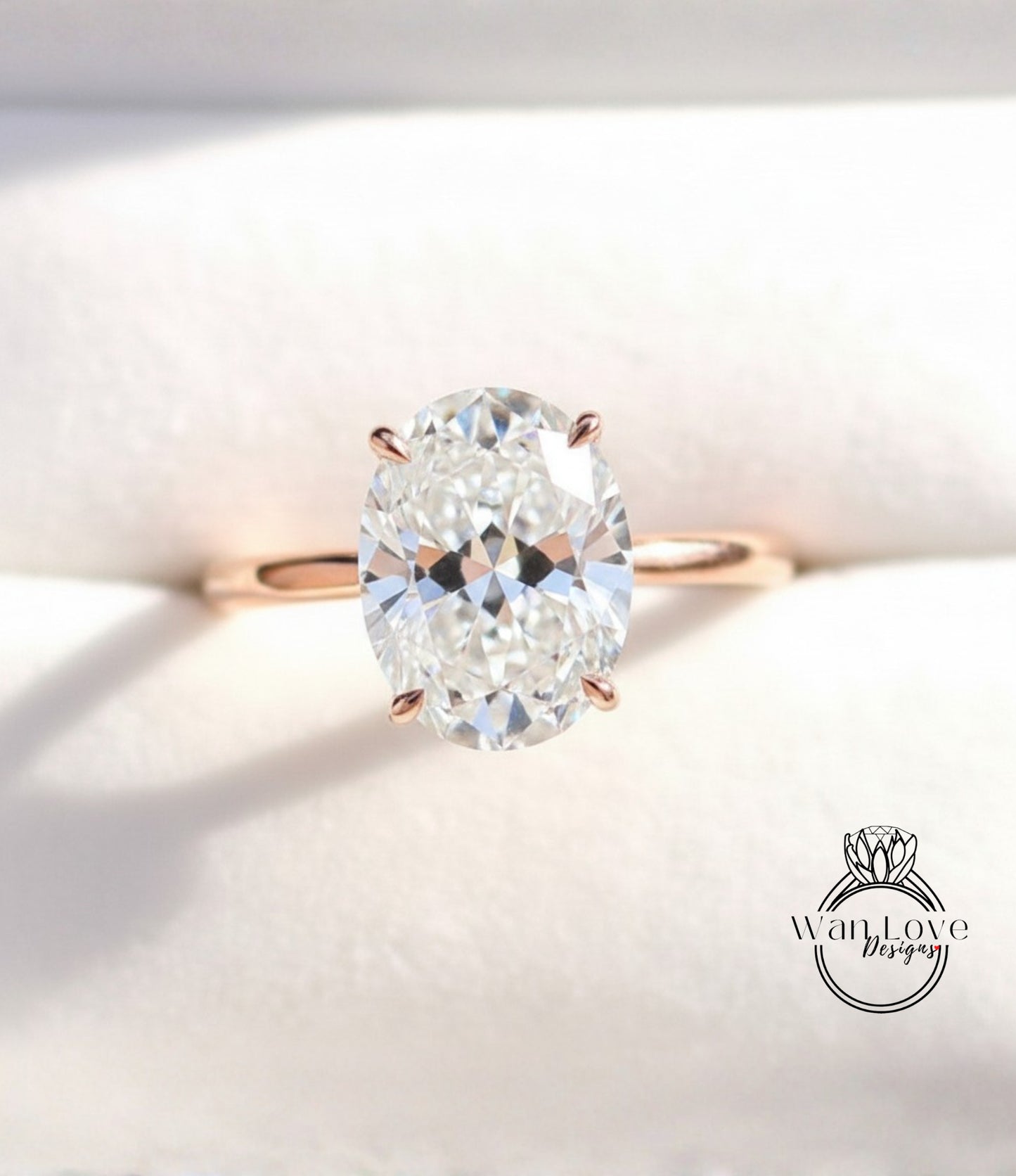A close-up image of a diamond engagement ring with a large oval-shaped diamond set in a gold band.