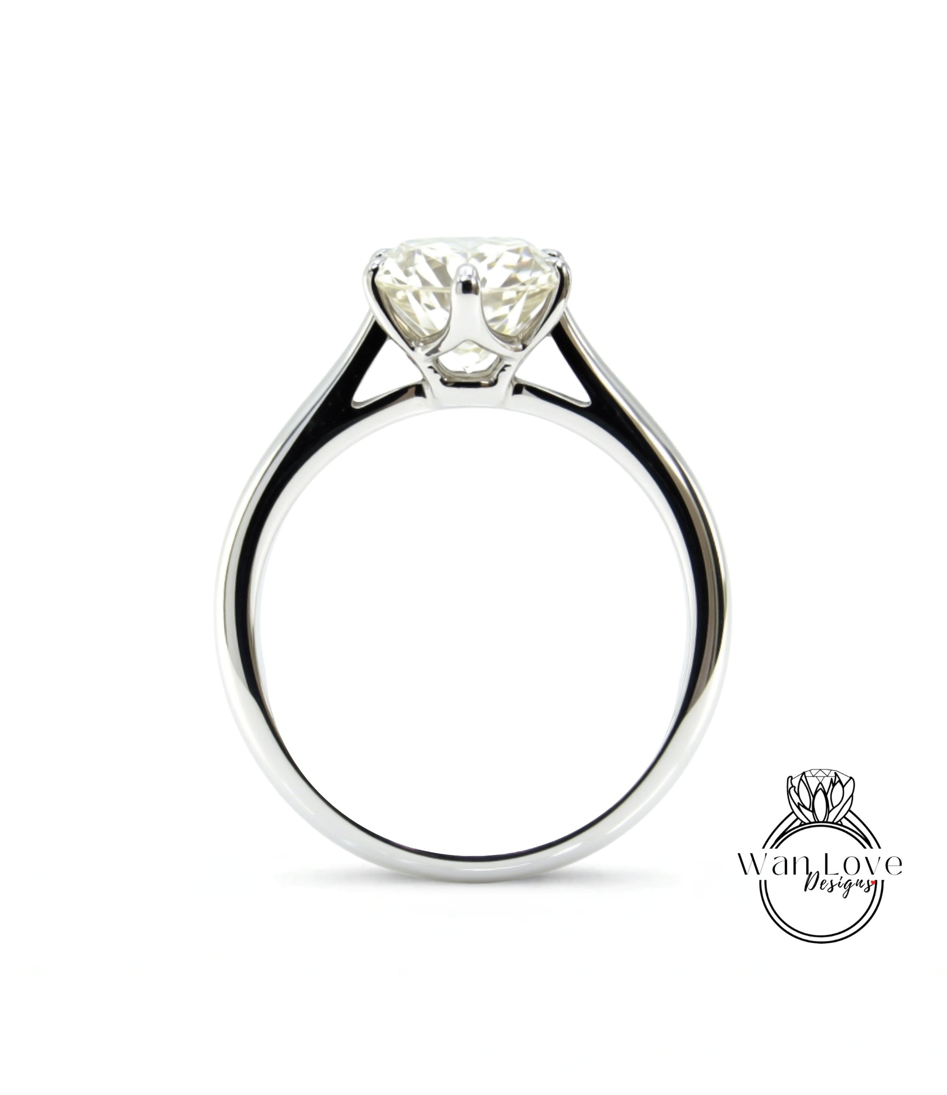 A close-up view of a silver engagement ring with a large, clear diamond set in the center.