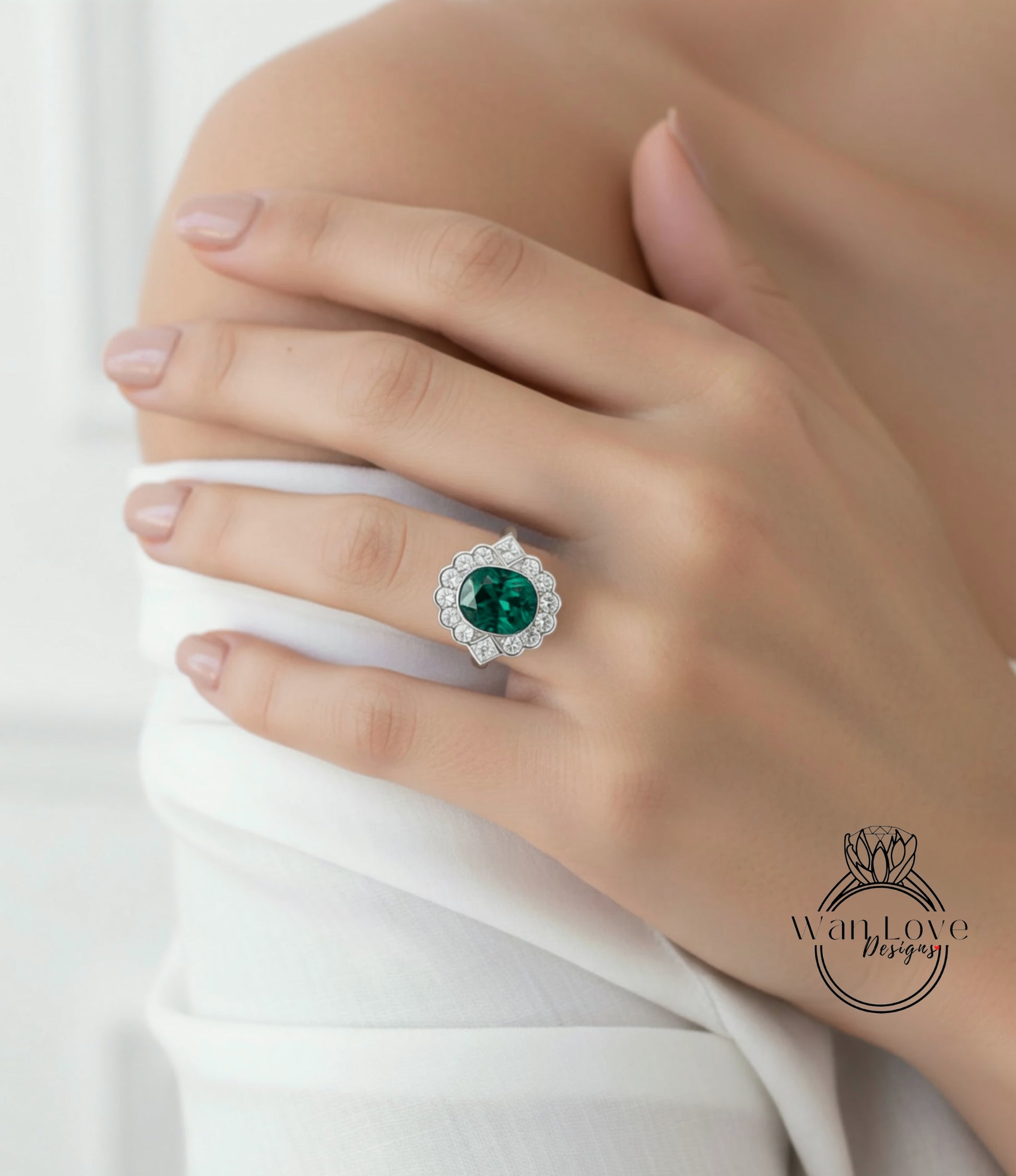 A close-up of a person's hand wearing a large, ornate ring with a large green gemstone.