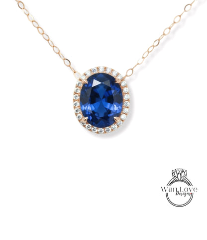 A necklace with a large oval-shaped blue gemstone surrounded by a halo of smaller diamonds.