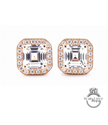 A pair of elegant earrings with large, clear gemstones set in a gold-toned metal frame.