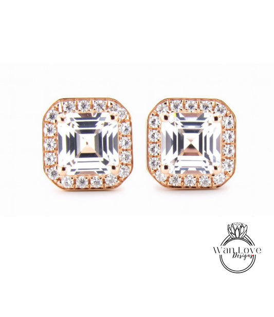 A pair of elegant earrings with large, clear gemstones set in a gold-toned metal frame.