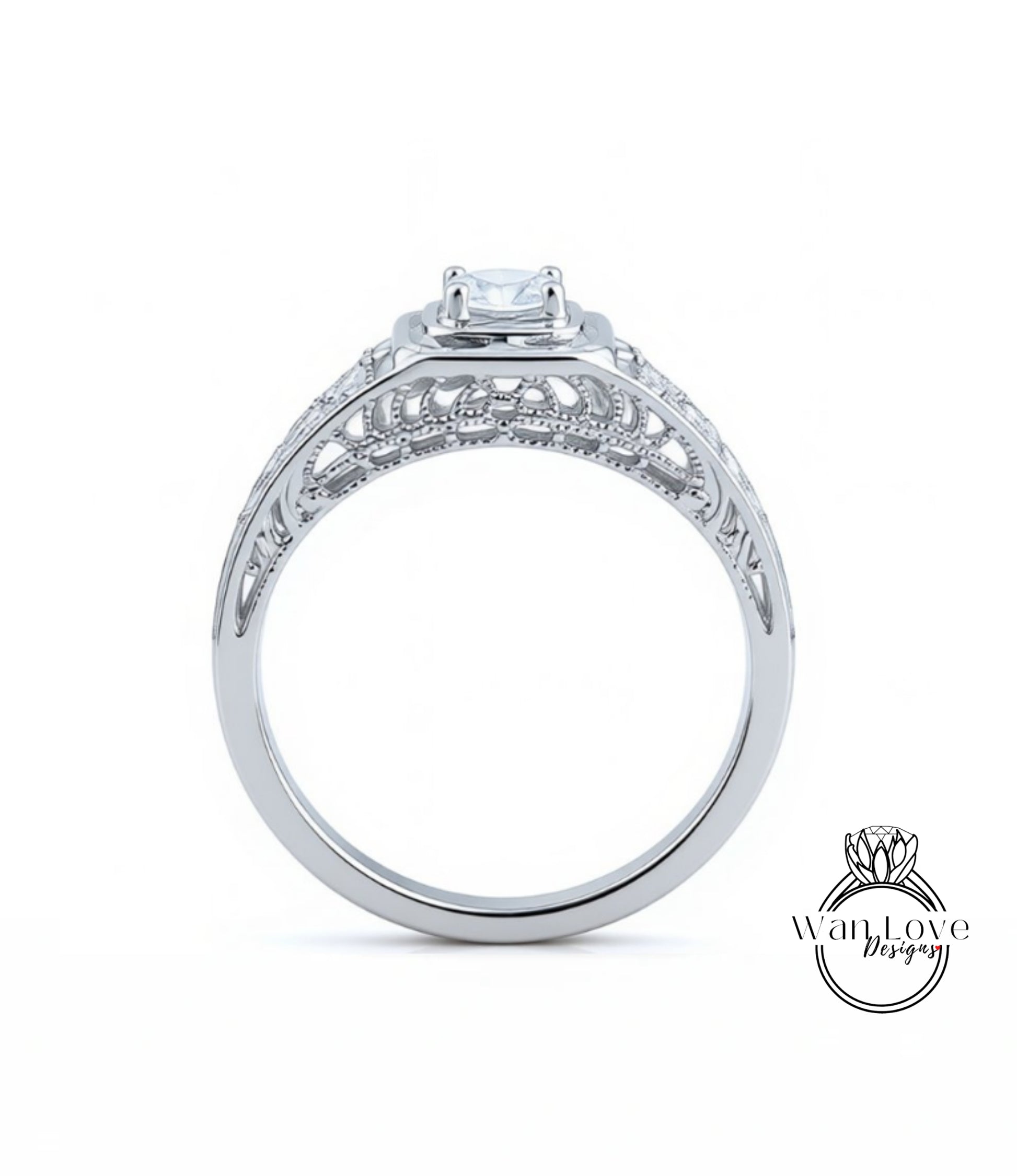 A silver engagement ring with a large central diamond and intricate metalwork detailing.
