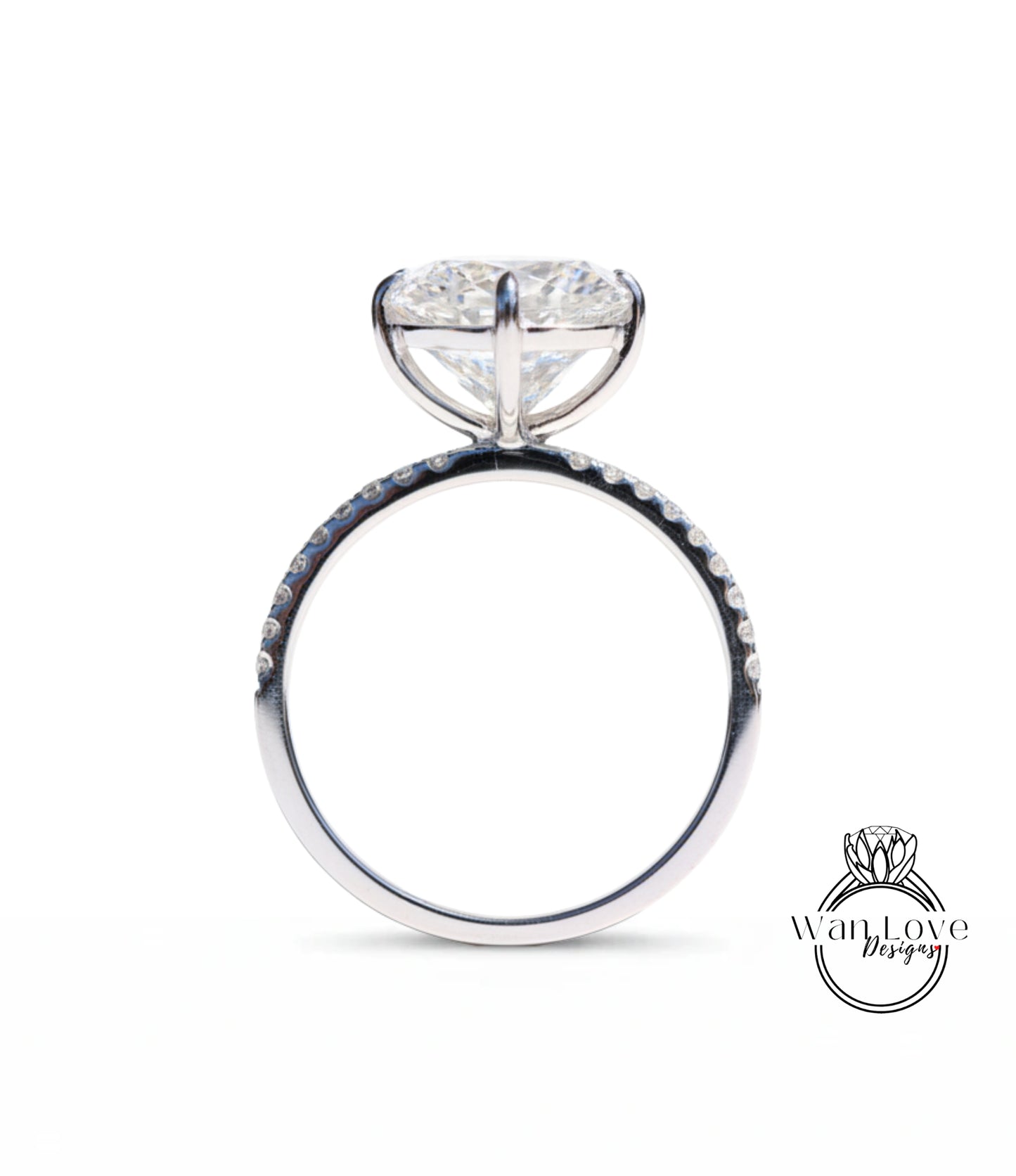 A close-up view of a silver engagement ring with a large, round diamond set in the center.