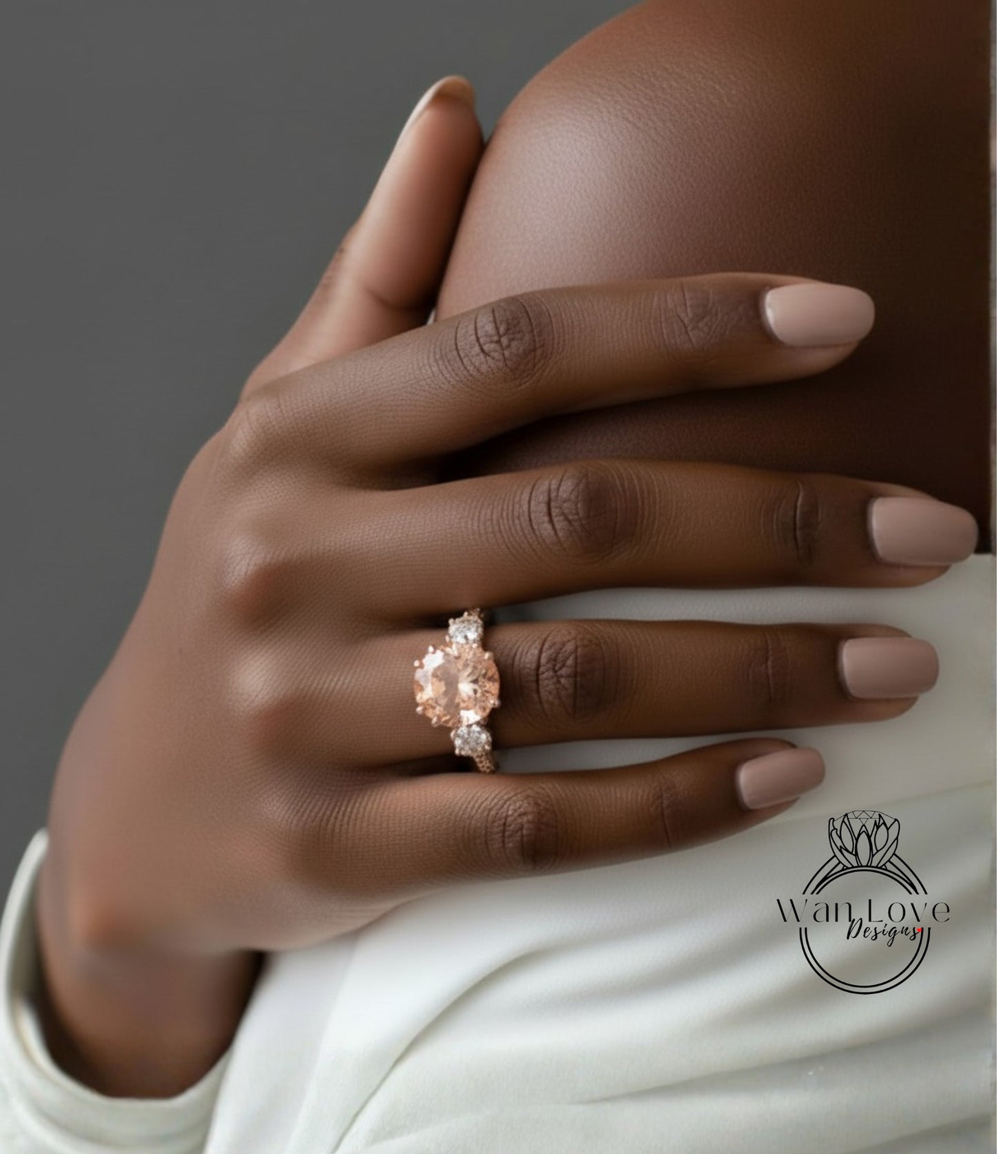 A close-up of a person's hand wearing a large, ornate ring with a large, round gemstone.