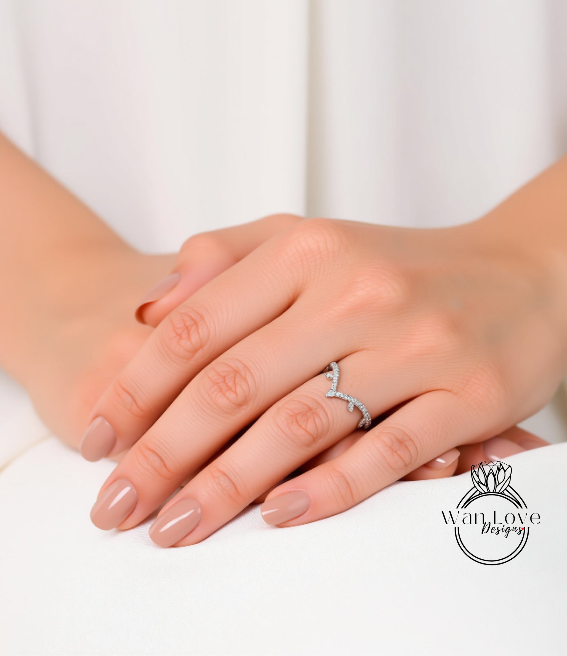 A close-up of a person's hands wearing a ring on the ring finger.