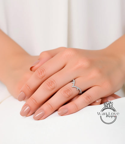 A close-up of a person's hands wearing a ring on the ring finger.