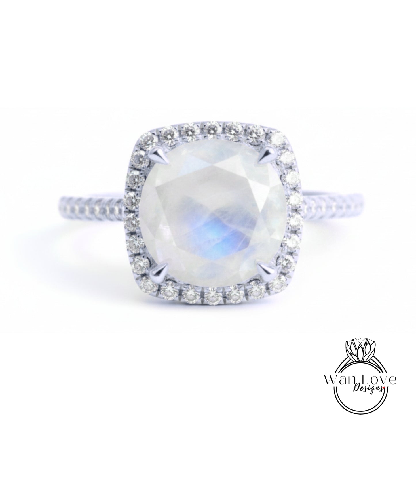 A diamond ring with a large oval-shaped gemstone, surrounded by a halo of smaller diamonds, set in a silver band.