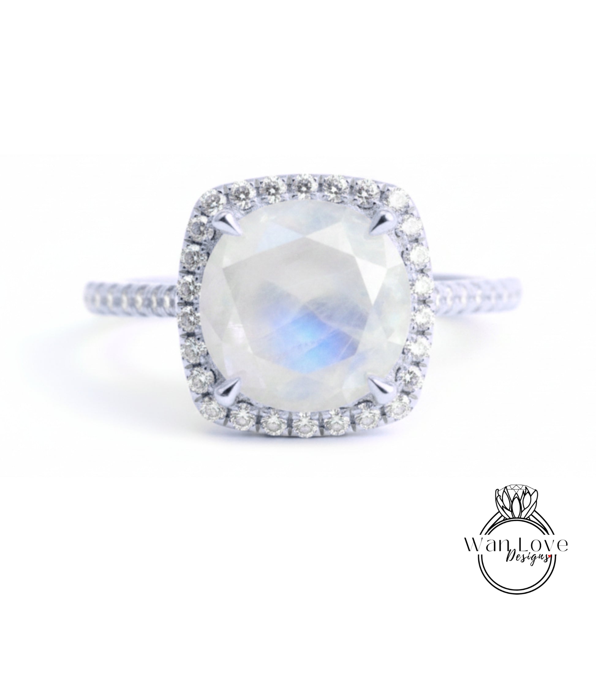 A diamond ring with a large oval-shaped gemstone, surrounded by a halo of smaller diamonds, set in a silver band.