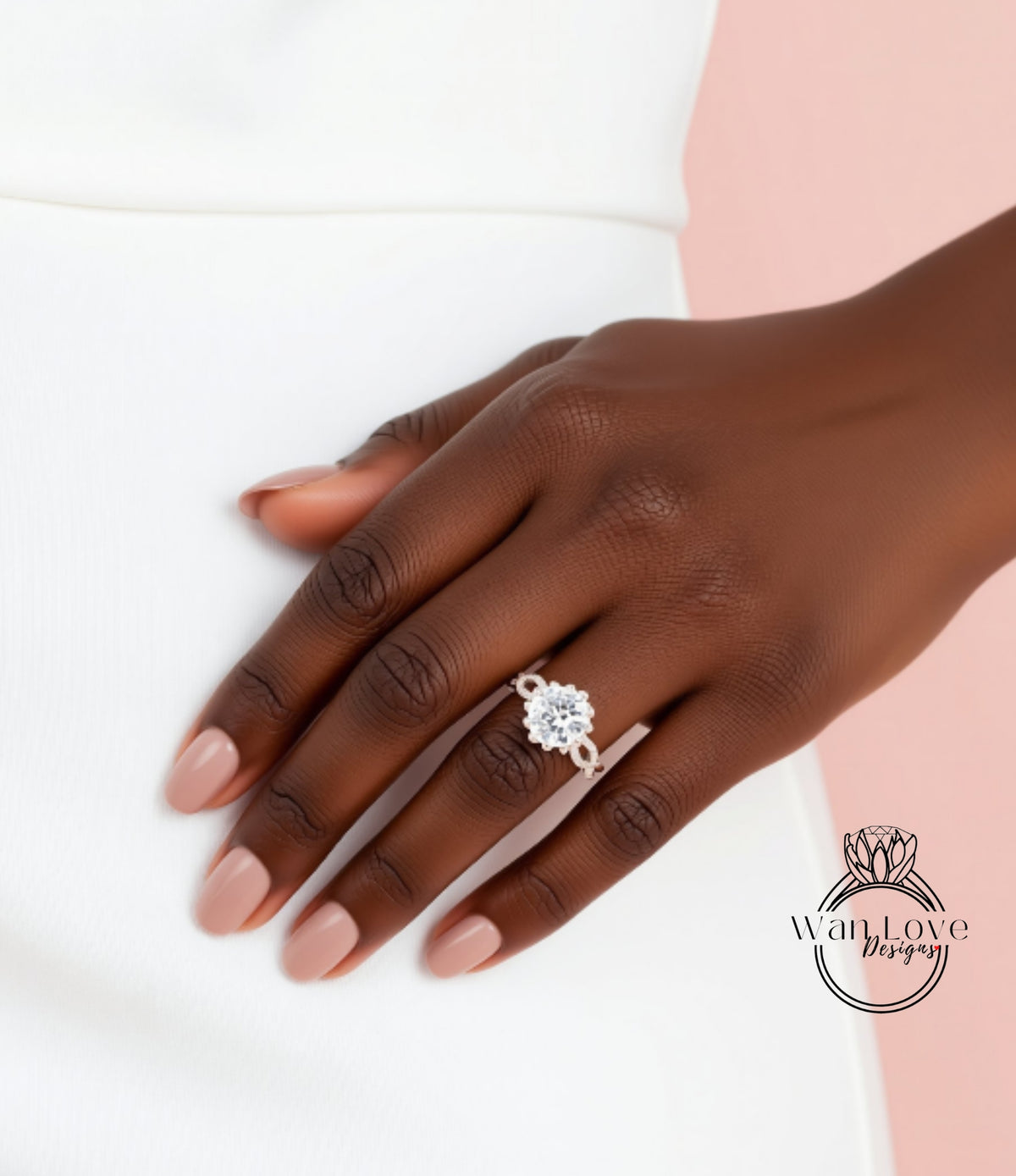 A close-up of a hand wearing a diamond engagement ring against a white background.