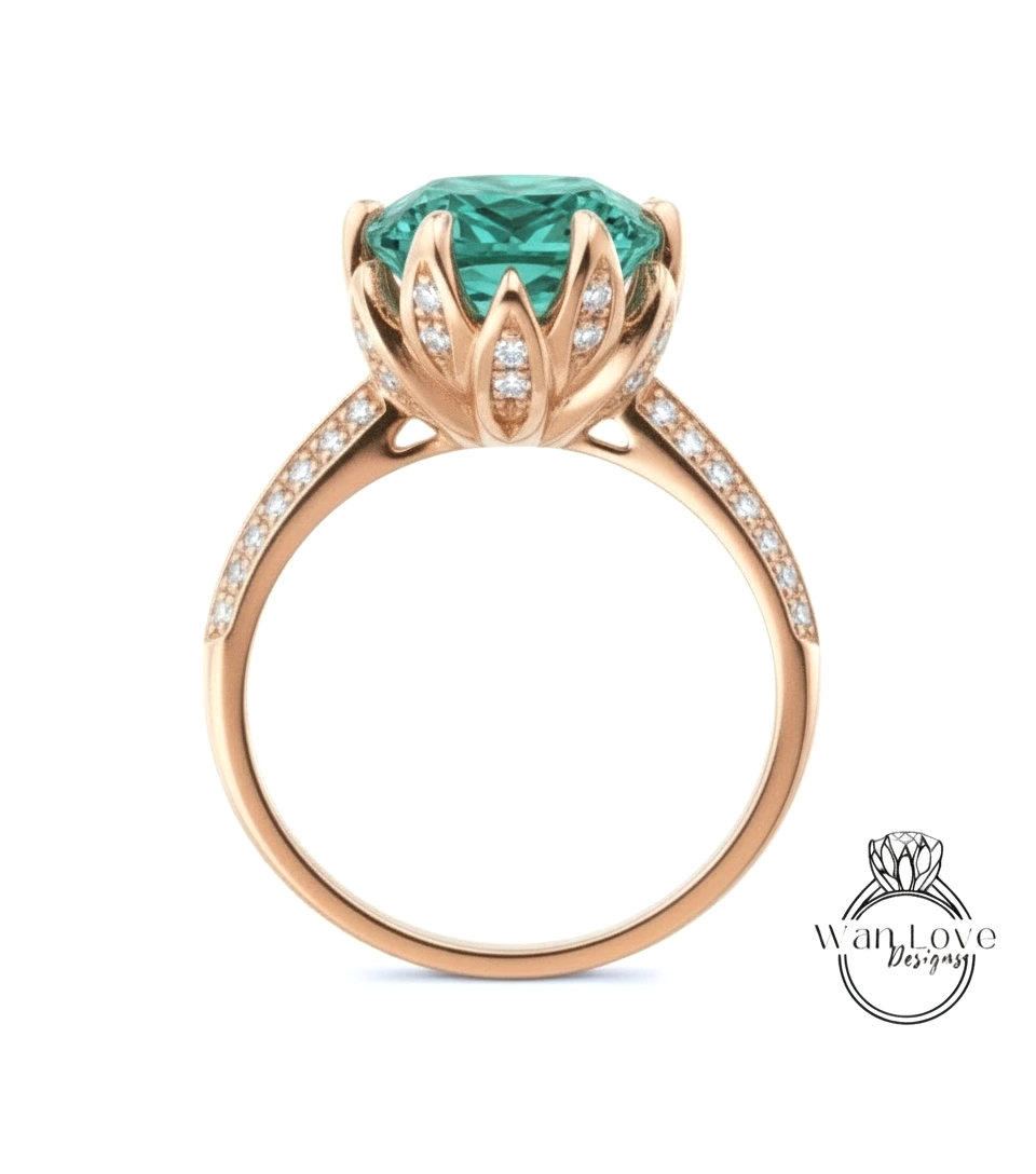 A gold ring with a large, green gemstone at the center, surrounded by smaller diamonds.