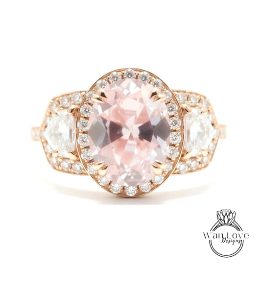 A close-up of a beautiful pink gemstone ring with a large oval-shaped gemstone surrounded by smaller diamonds.