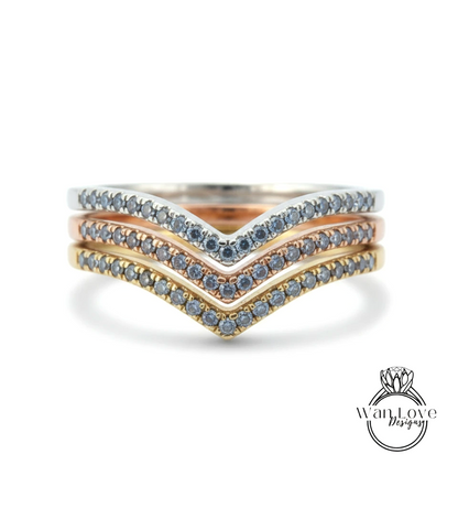 A ring with three layers of rings, each with a diamond set in a different color.