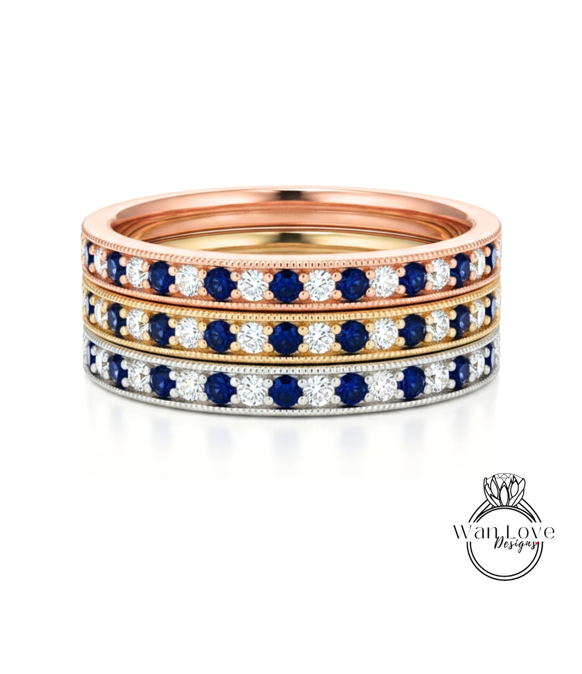 A stack of three rings with blue and white gemstones set in a gold band.