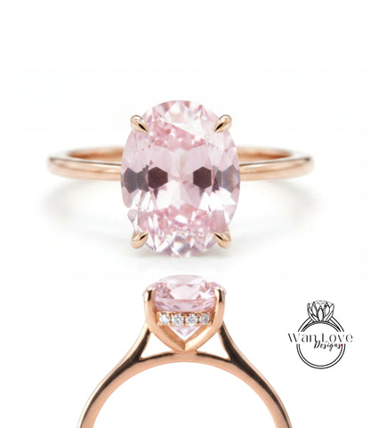 a beautiful pink gemstone ring with a large oval-shaped gemstone set in a rose gold band.