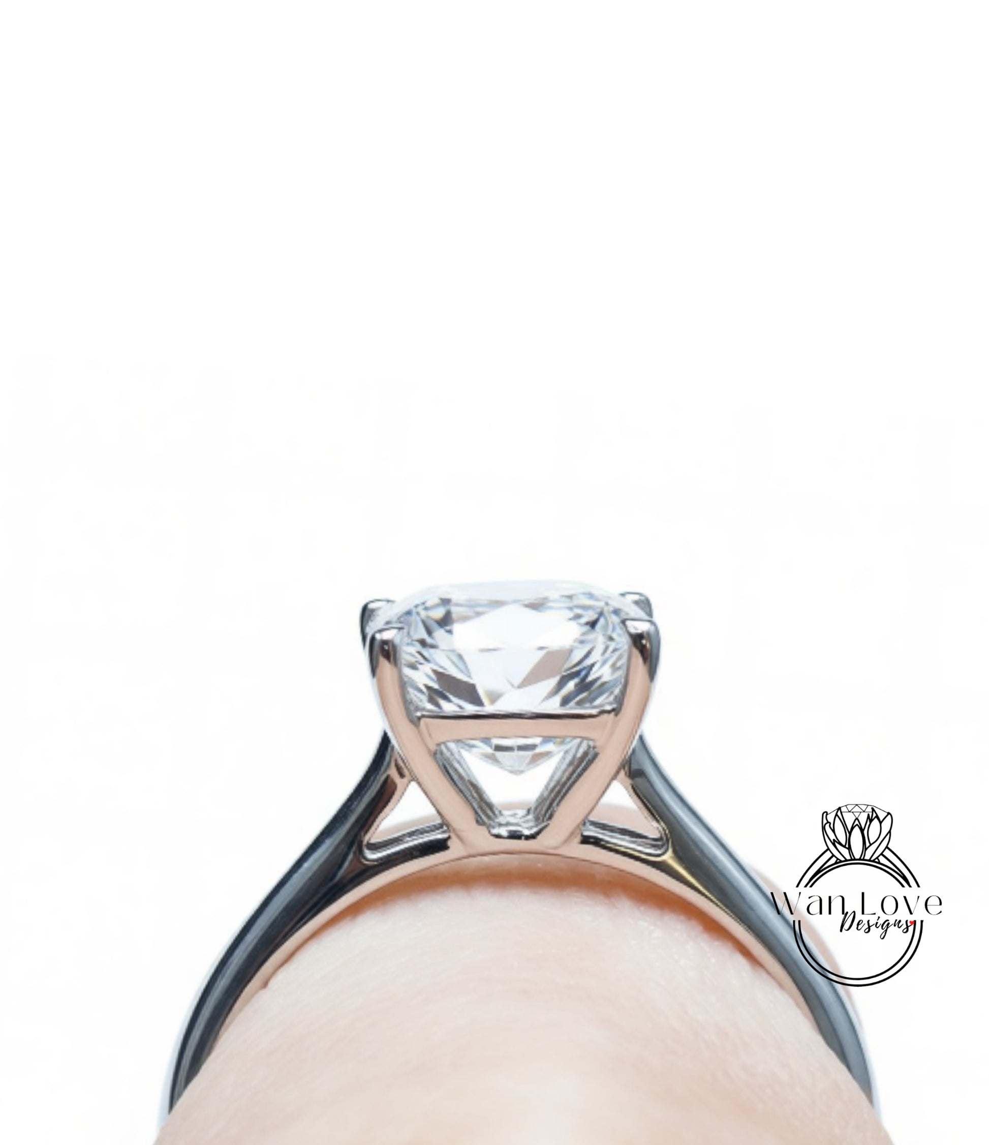 A close-up view of a diamond engagement ring with a large central diamond set in a silver band.