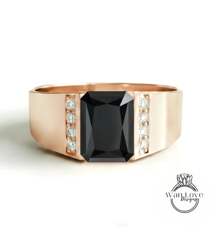 A gold ring with a large black gemstone in the center, surrounded by smaller diamonds.