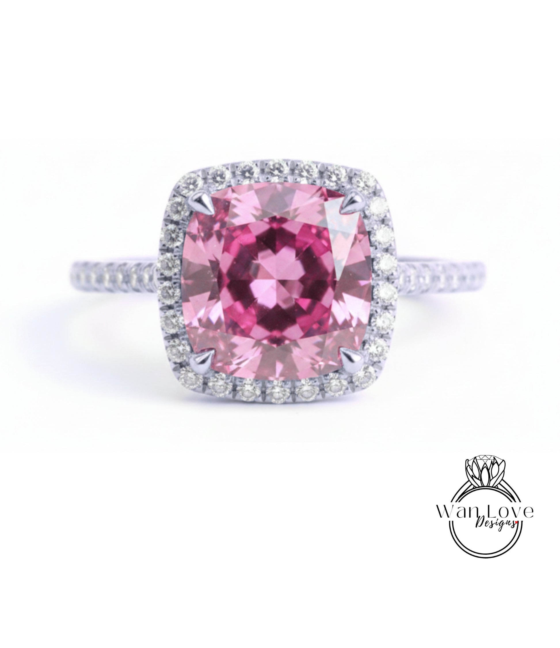 A large, pink gemstone ring with a halo of smaller diamonds around the center stone.