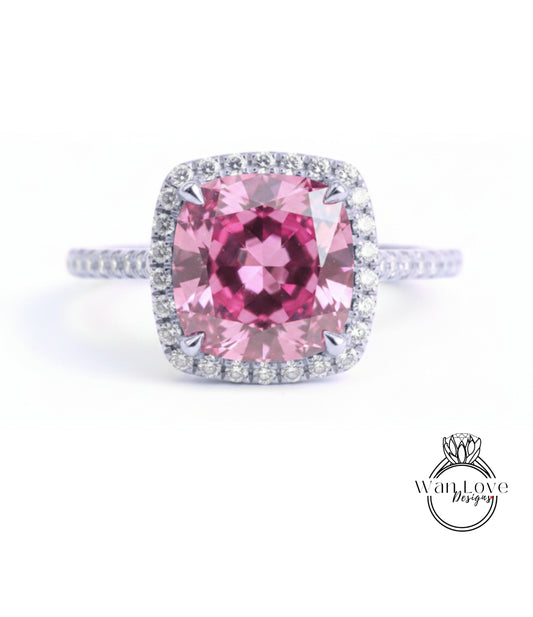 A large, pink gemstone ring with a halo of smaller diamonds around the center stone.
