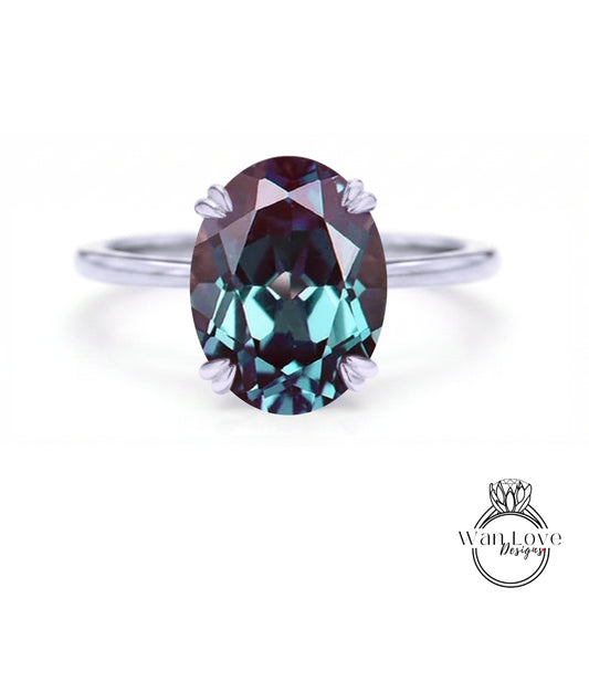 A close-up image of a ring featuring a large oval-shaped gemstone, likely a sapphire, set in a silver band.