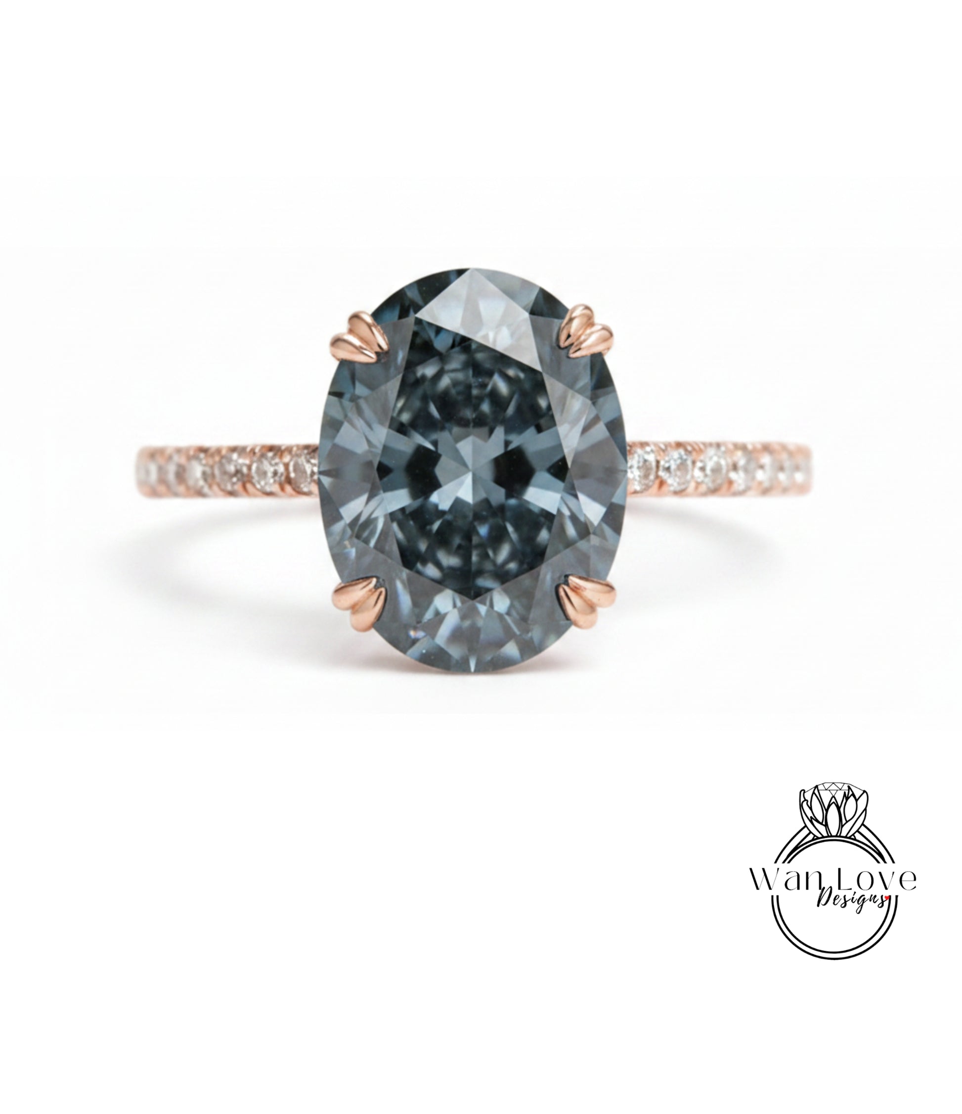 A close-up of a large, dark blue diamond ring with a rose gold band and small diamonds around the band.