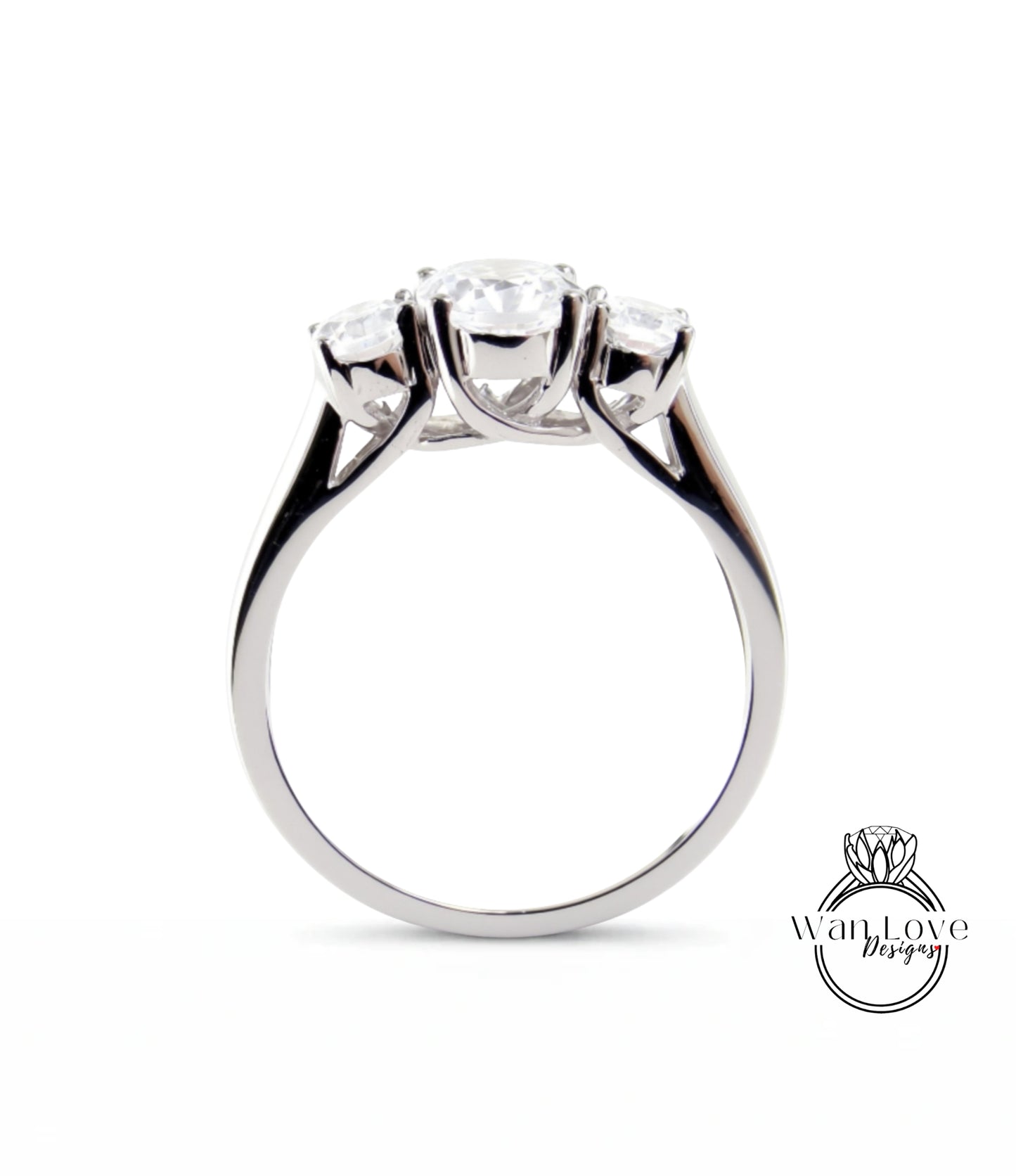 A silver ring with three clear gemstones set in the band.