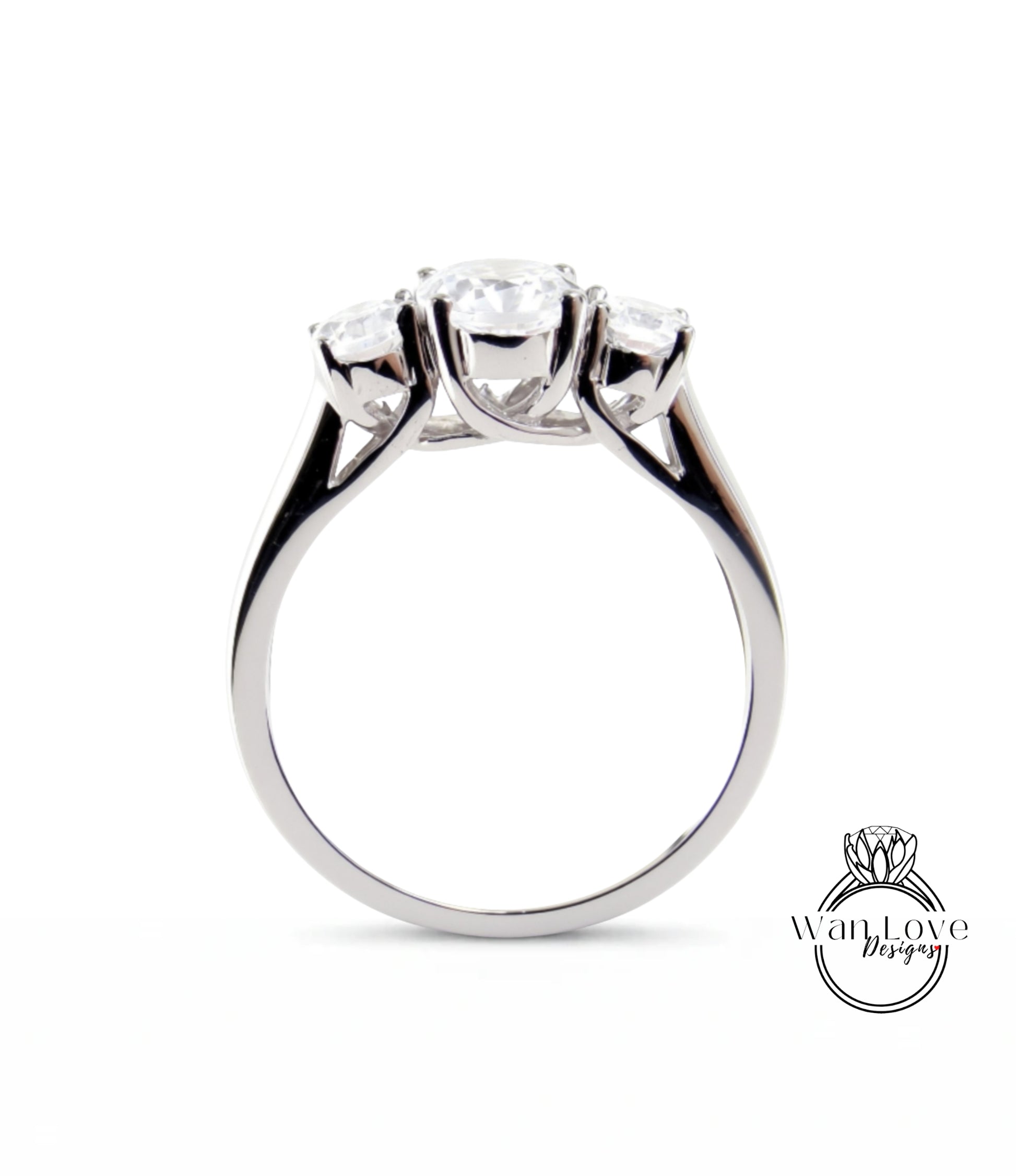 A silver ring with three clear gemstones set in the band.
