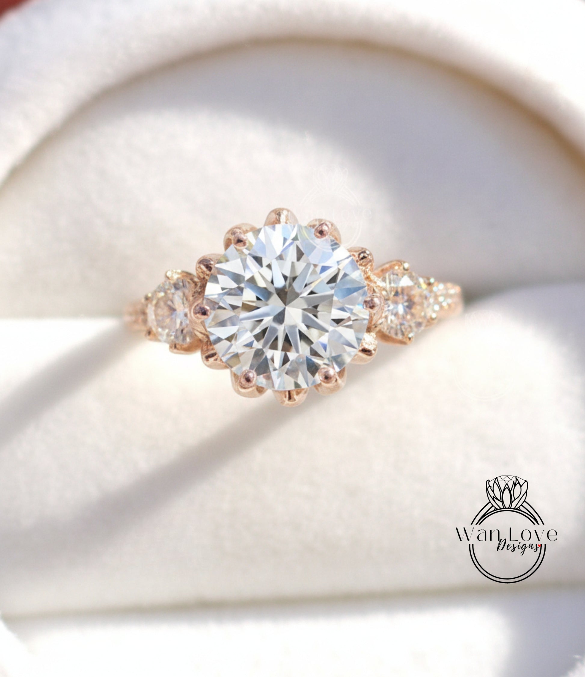 A close-up image of a beautiful diamond engagement ring with a large central diamond surrounded by smaller diamonds on either side.