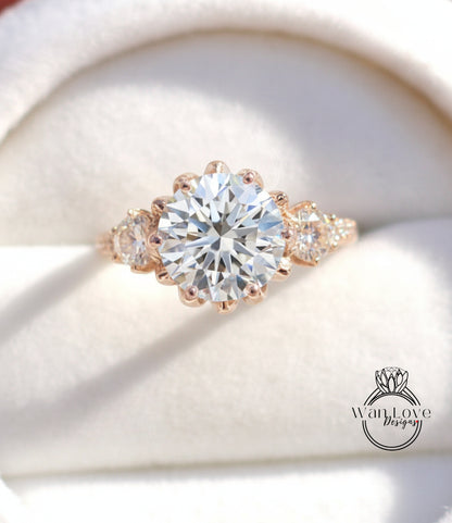 A close-up image of a beautiful diamond engagement ring with a large central diamond surrounded by smaller diamonds on either side.