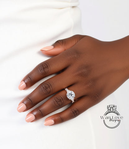A close-up of a person's hand wearing a diamond engagement ring.