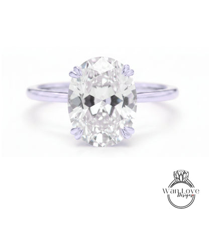 A close-up of a diamond engagement ring with a large oval-shaped diamond set in a silver band.