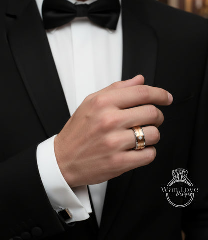 A close-up of a man's hand wearing a gold ring and a black tuxedo jacket.