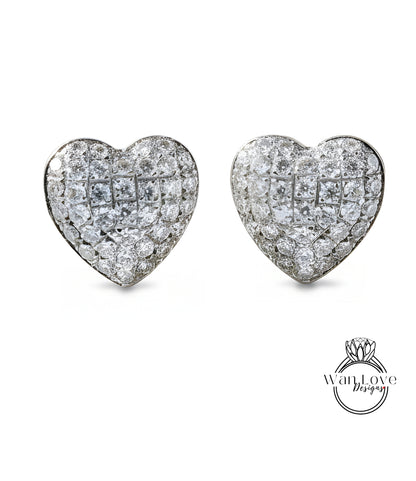 A pair of elegant diamond-encrusted earrings in the shape of hearts.