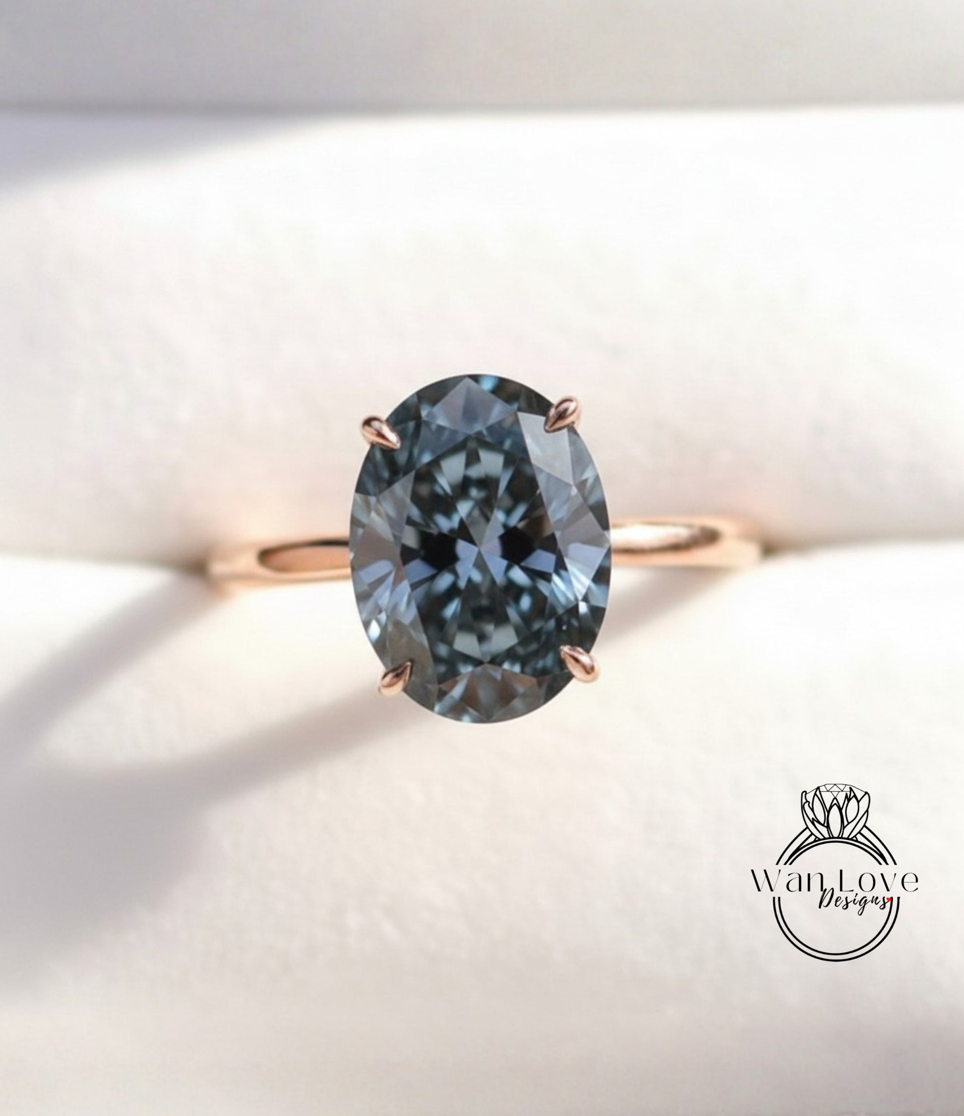 A close-up image of a gold ring with a large oval-shaped blue gemstone set in the center.