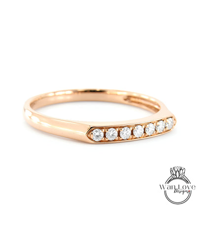 A gold ring with a row of diamonds set in the band.