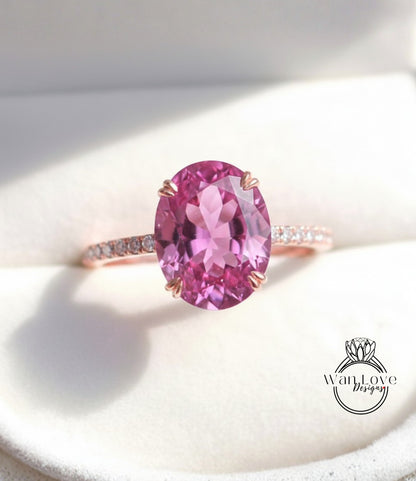 A close-up image of a pink gemstone ring with a large oval-shaped gemstone set in a rose gold band.
