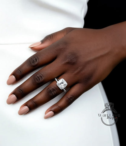 A close-up of a hand wearing a large diamond engagement ring.