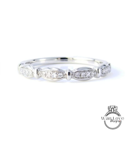 A silver ring with a row of small diamonds set in the center.