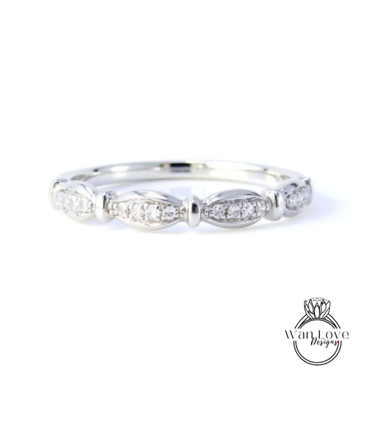 A silver ring with a row of small diamonds set in the center.