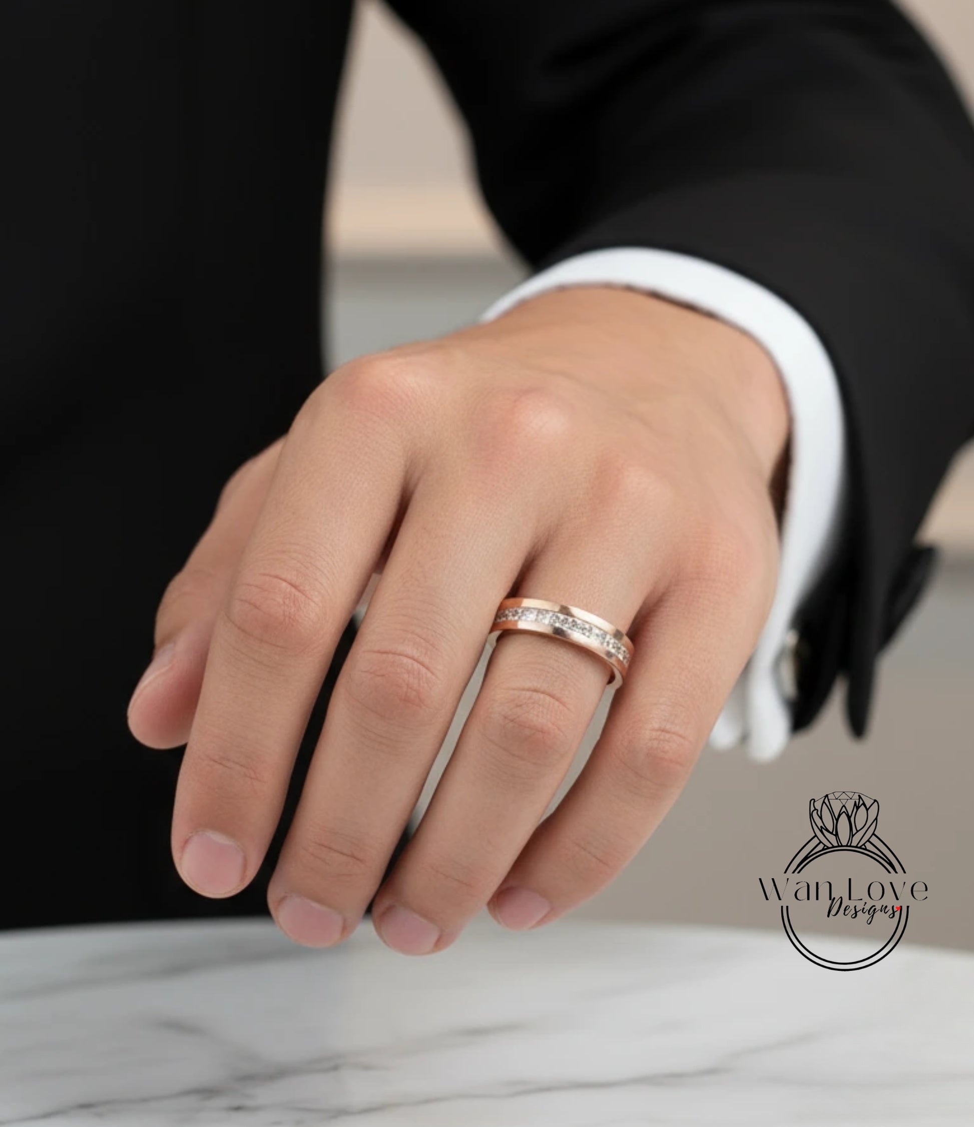A close-up of a person's hand wearing a gold wedding ring on the ring finger.