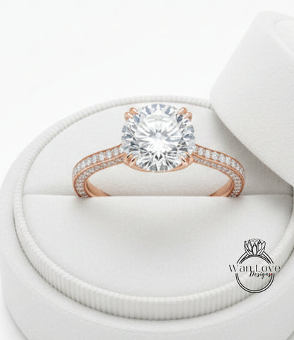 A large, round diamond engagement ring is displayed in a white jewelry box.