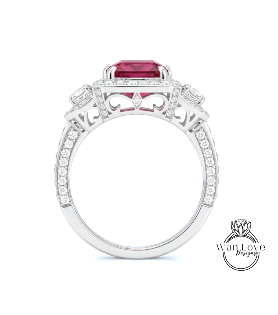 A silver ring with a large red gemstone, surrounded by smaller diamonds and intricate designs.