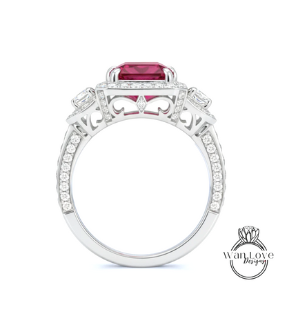 A silver ring with a large red gemstone, surrounded by smaller diamonds and intricate designs.