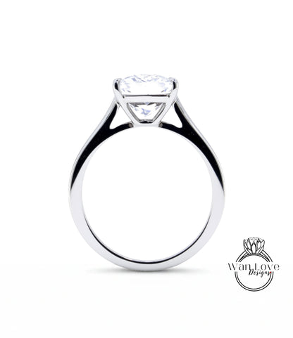 A silver engagement ring with a large, clear diamond set in the center of the band.