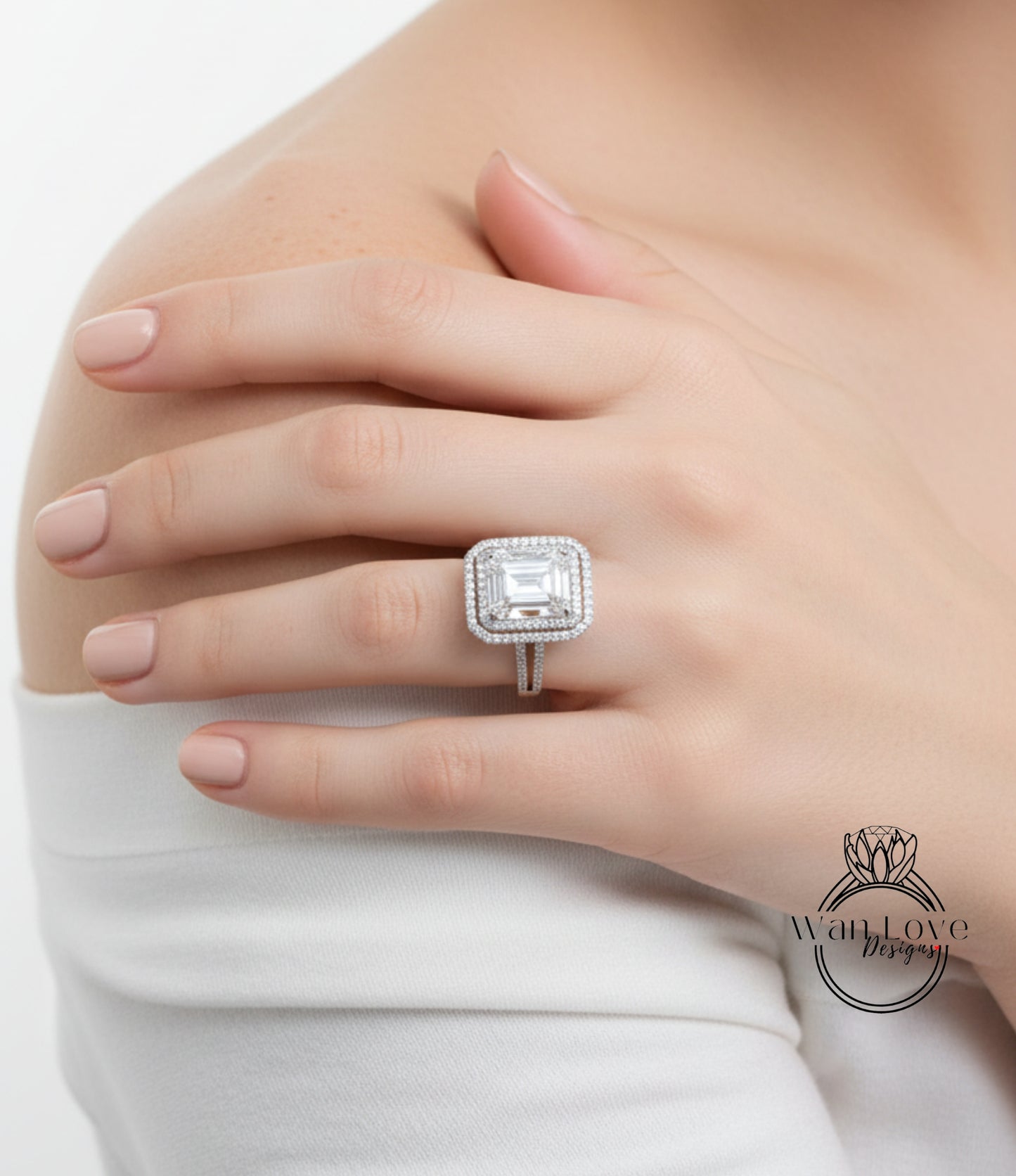 A close-up of a person's hand wearing a large diamond ring on the ring finger.