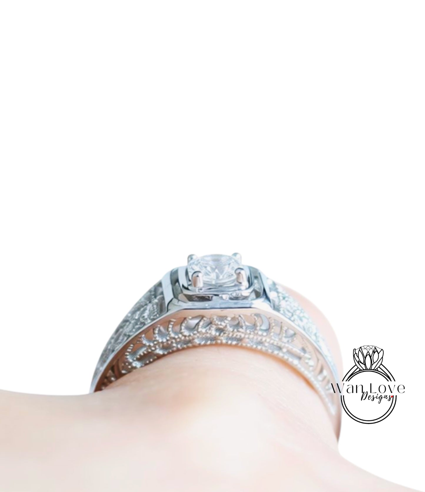 A close-up view of a diamond engagement ring on a person's hand, showcasing the intricate design and sparkling gemstone.