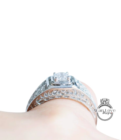 A close-up view of a diamond engagement ring on a person's hand, showcasing the intricate design and sparkling gemstone.