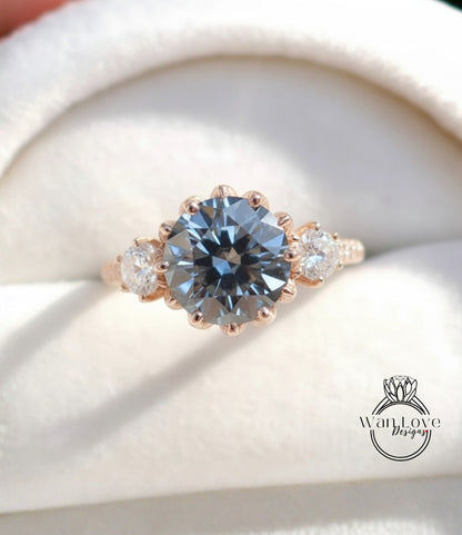 A close-up image of a gold ring with a large blue gemstone, showcasing the intricate details and craftsmanship of the jewelry.