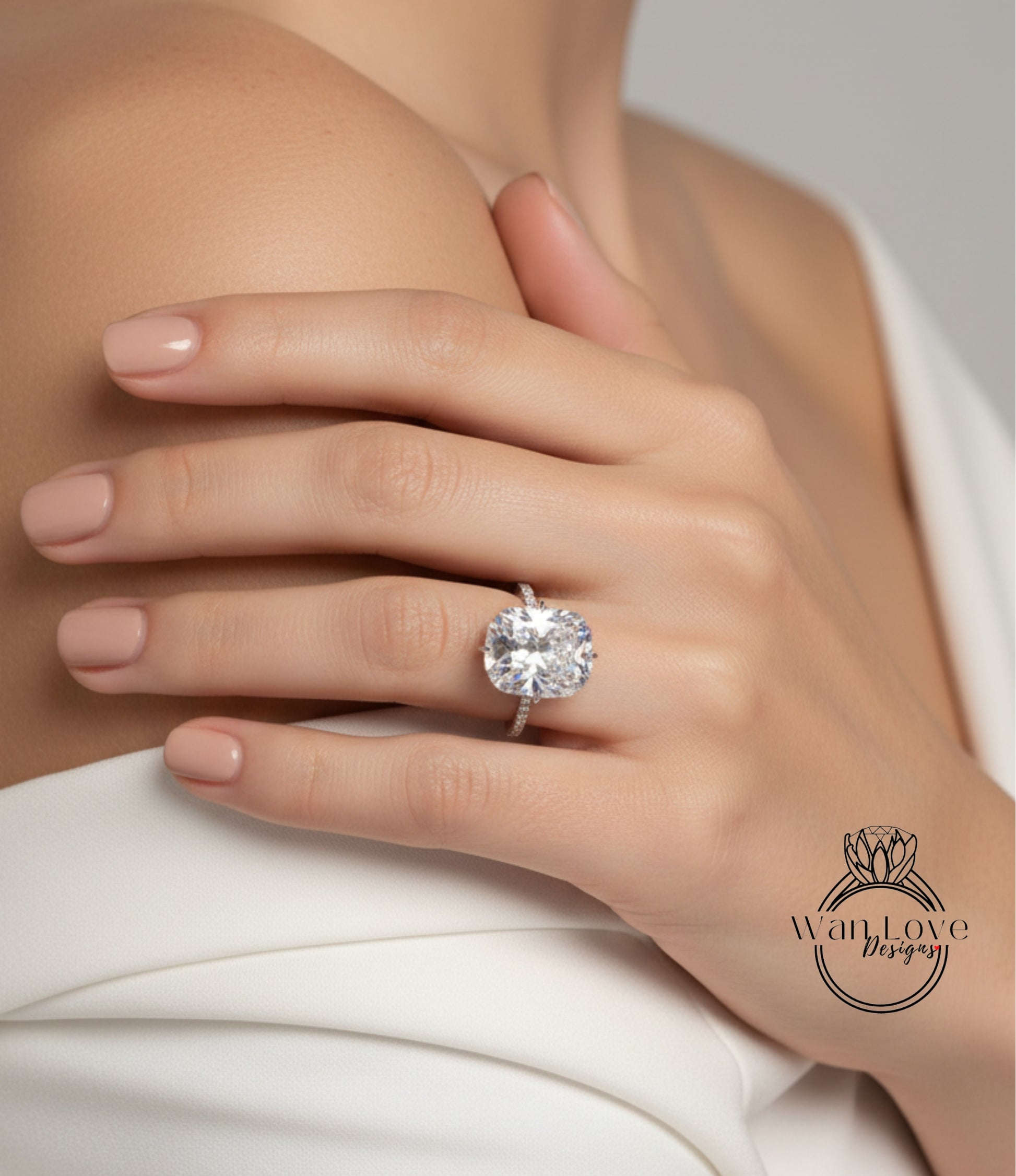 A close-up of a person's hand wearing a large, sparkling diamond ring.