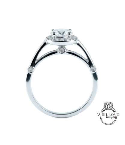 A silver engagement ring with a large central diamond surrounded by smaller diamonds.